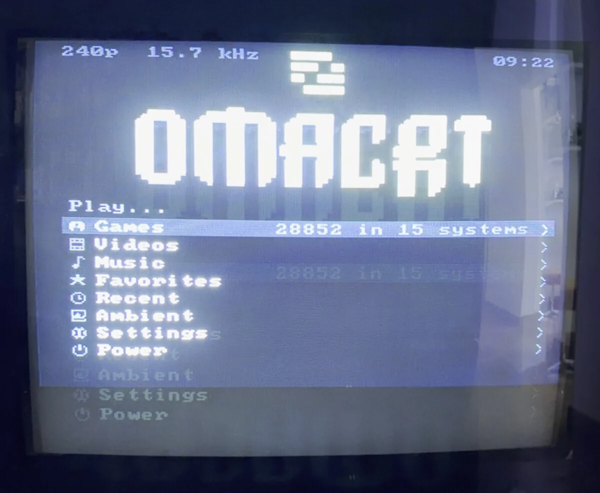The launcher photographed on the television rather than captured from the framebuffer, so the phosphor and the bloom are the set's own