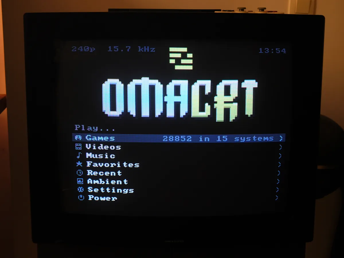 The same home menu photographed on the television, with real scanlines and phosphor glow.